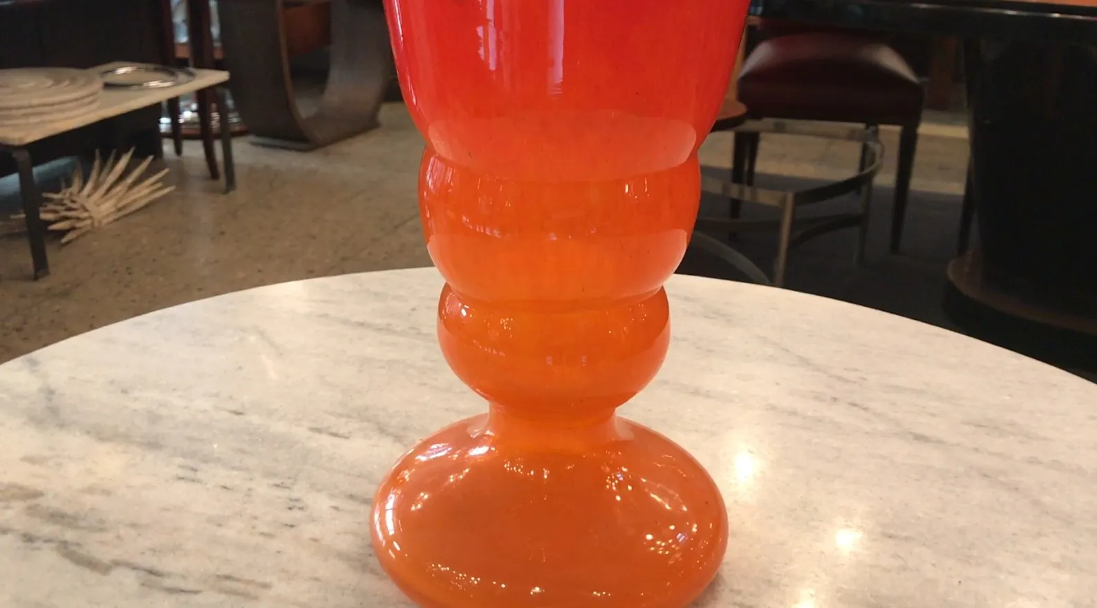 Antique glass in red and orange tones, signed by Schneider, on marble table.