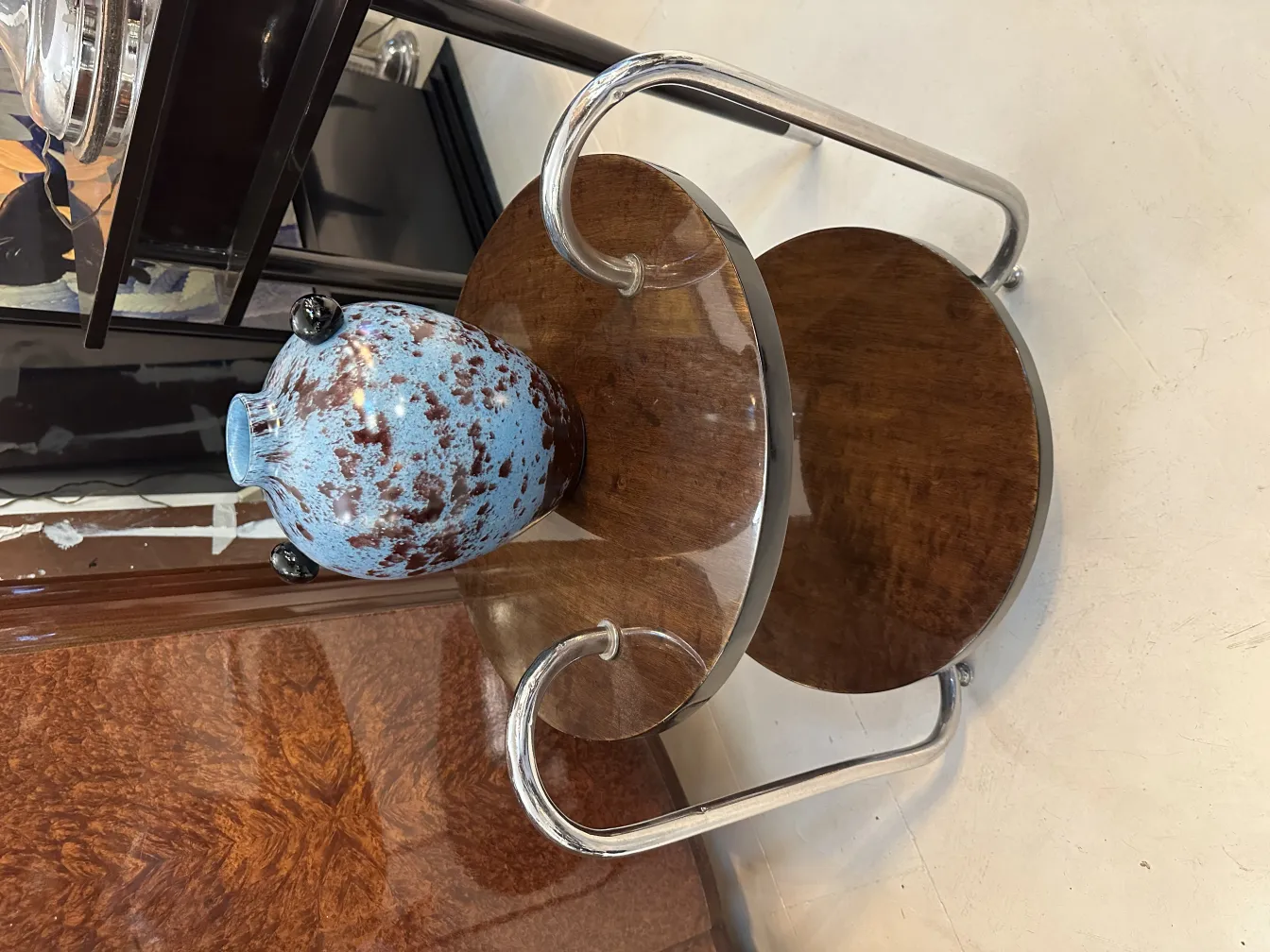 blue glass with brown spots on a wooden table