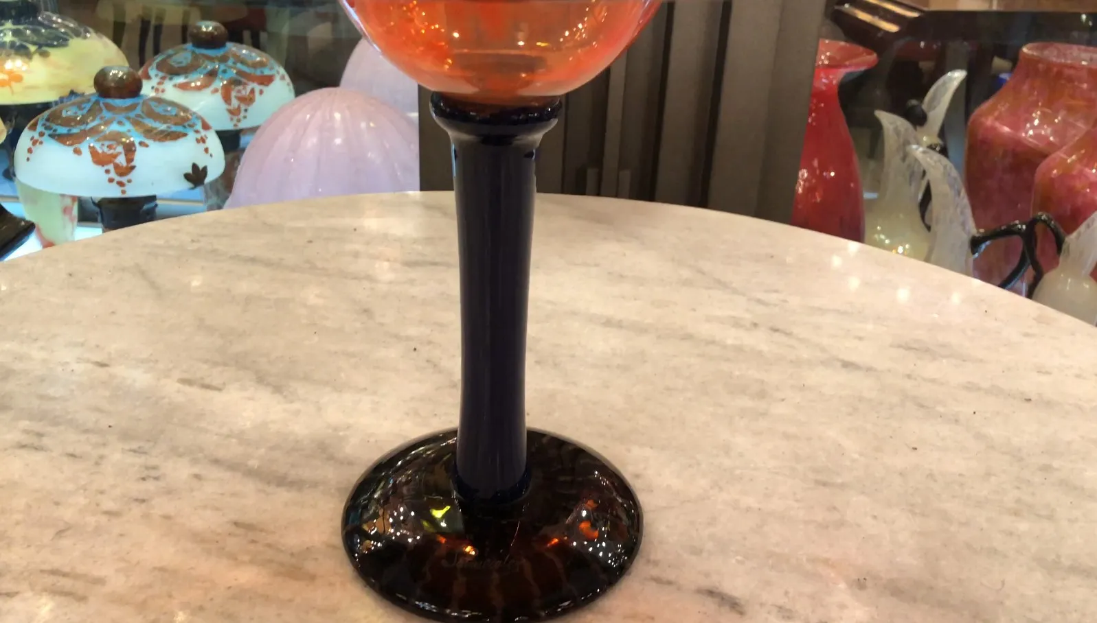 orange signed glass with dark base