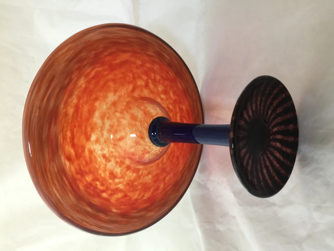 Orange signed glass Schneider with black base, antique style.