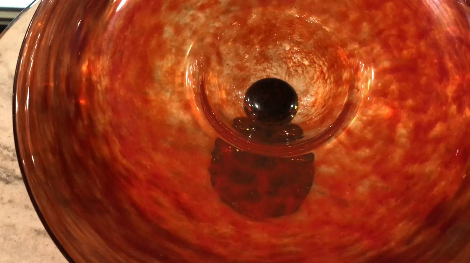 Interior view of an antique signed glass by Schneider with warm tones.