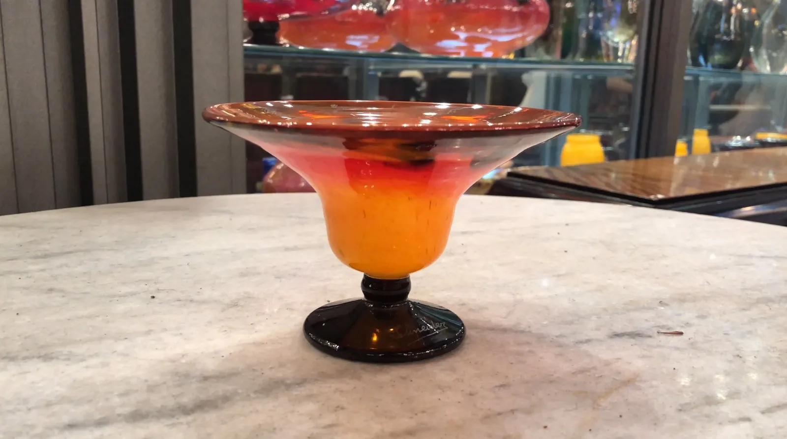 elegant warm colored signed glass set against an antique background.