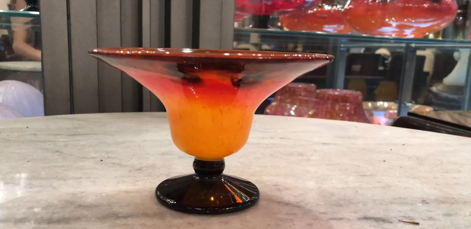 signed glass with black base and warm colors