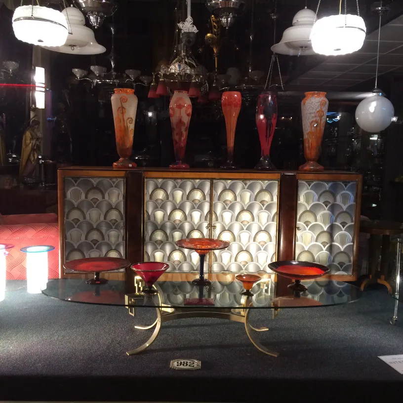 signed glass by schneider in an antique setting with decorative vases