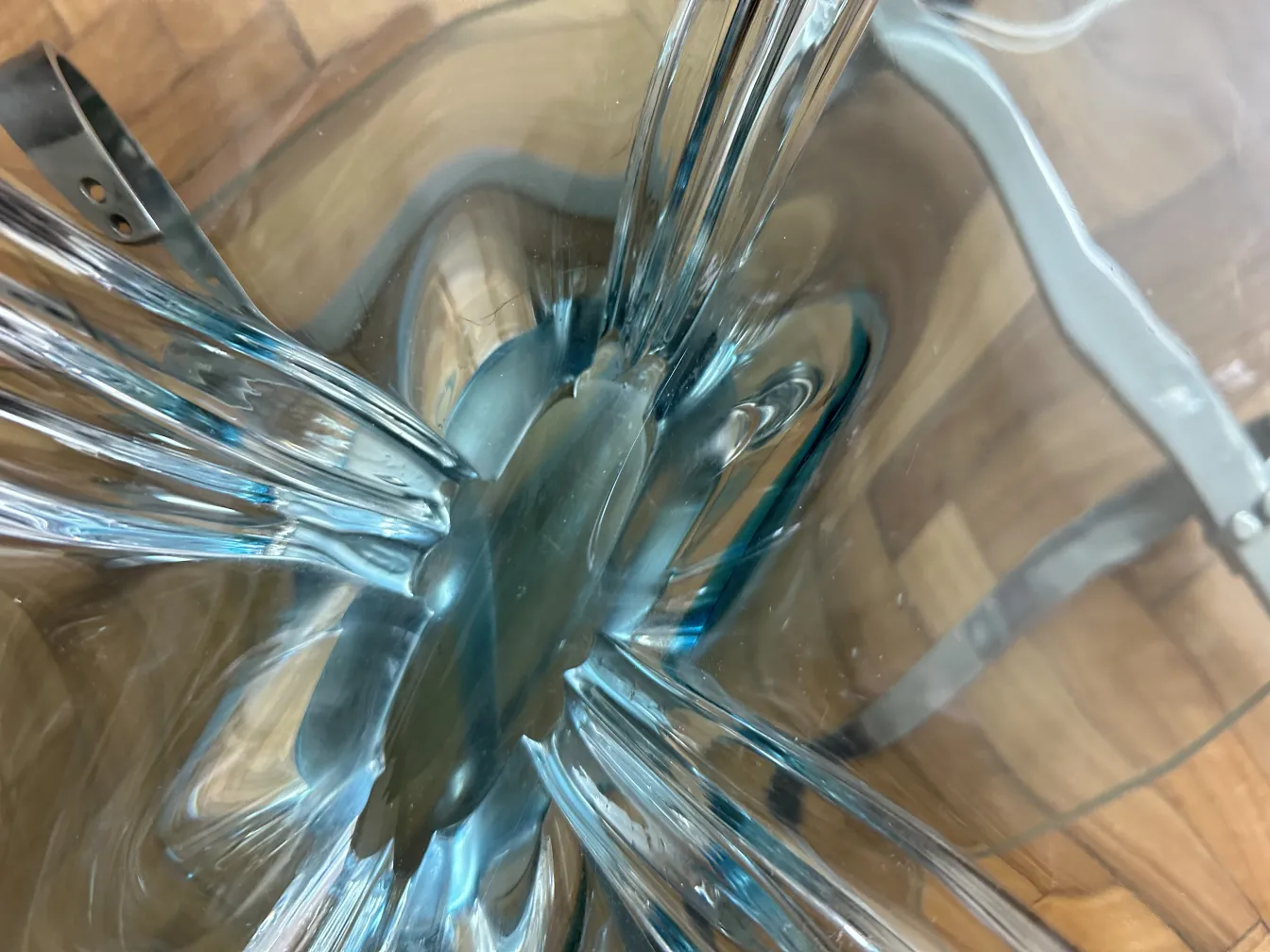 Top view of an antique murano glass with blue and clear tones, fluid and decorative details.