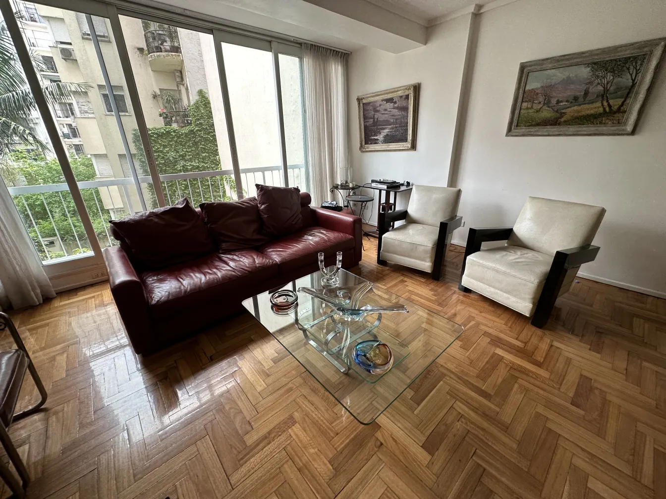 chairs and sofa in living room with murano glass