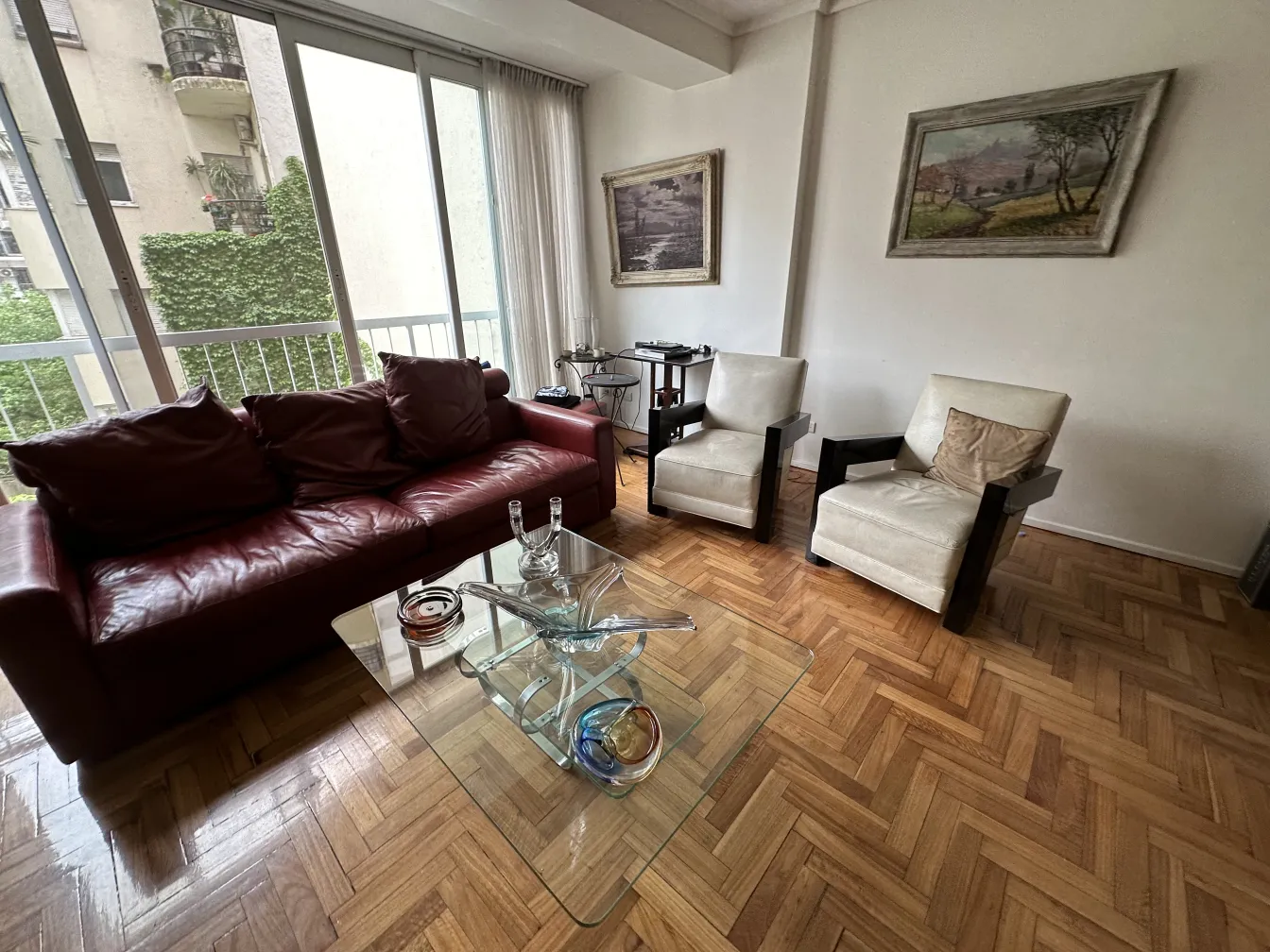 Antique Murano glass on a coffee table with armchairs