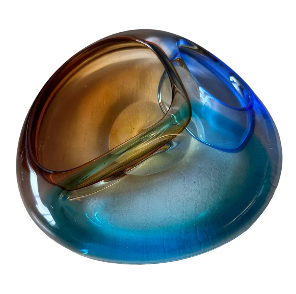 murano glass piece with amber and blue colors, fluid shape