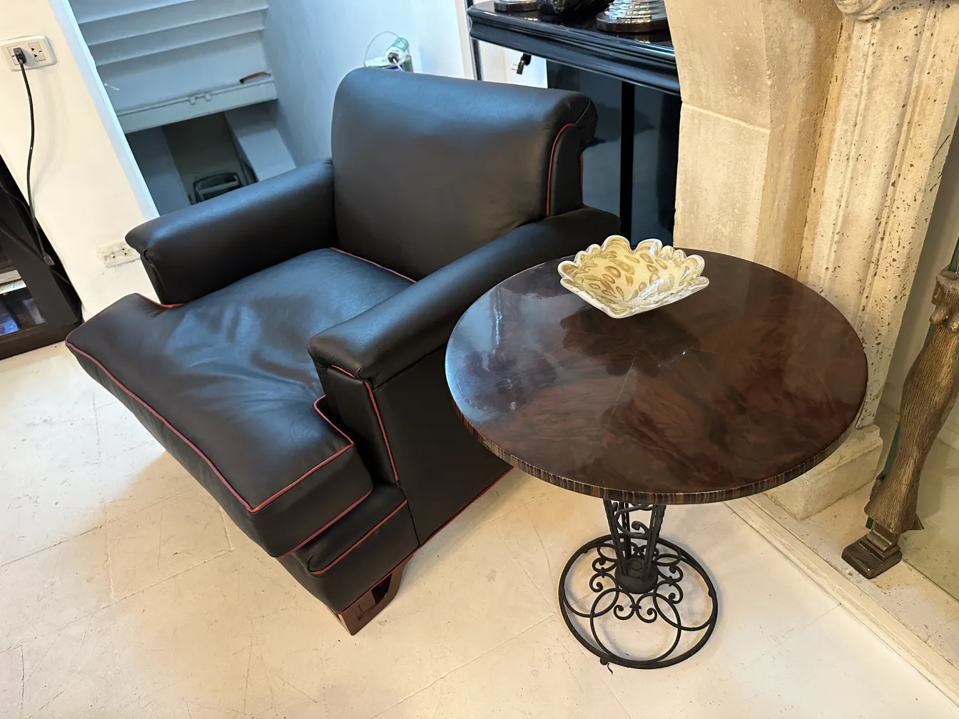 black armchair with cushions and coffee table featuring glass detail