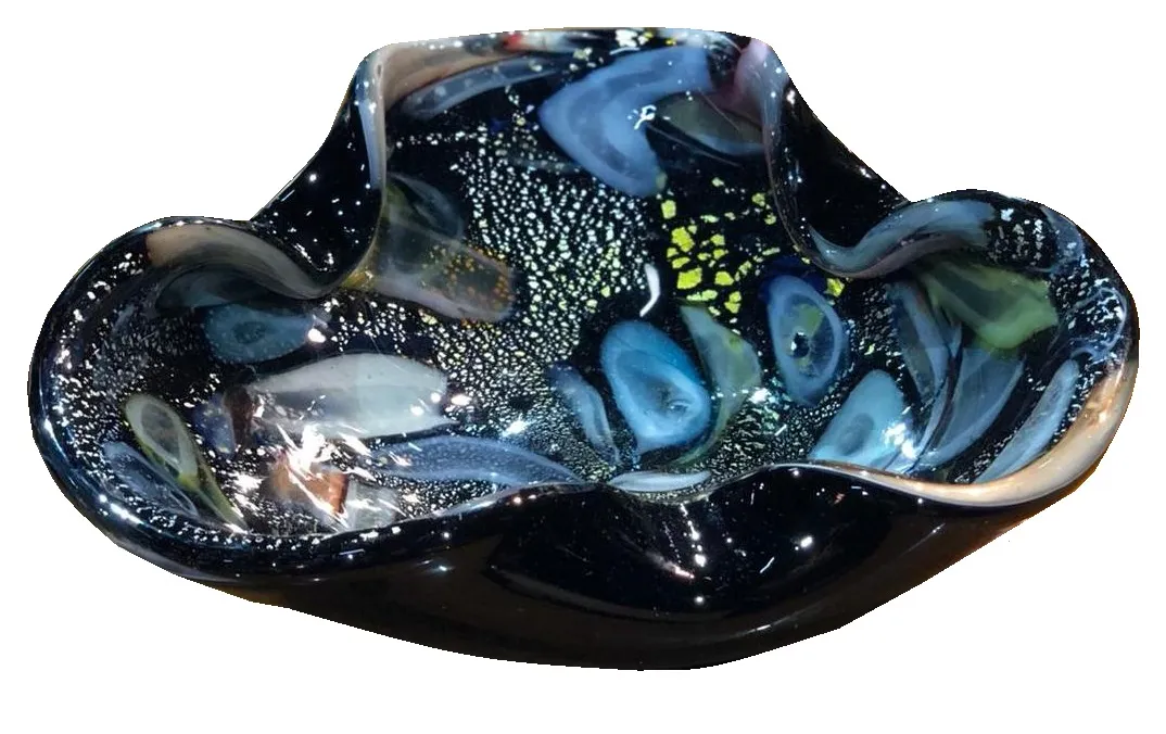 Ancien cristal de Murano avec des couleurs vives et des formes ondulées sur fond sombre