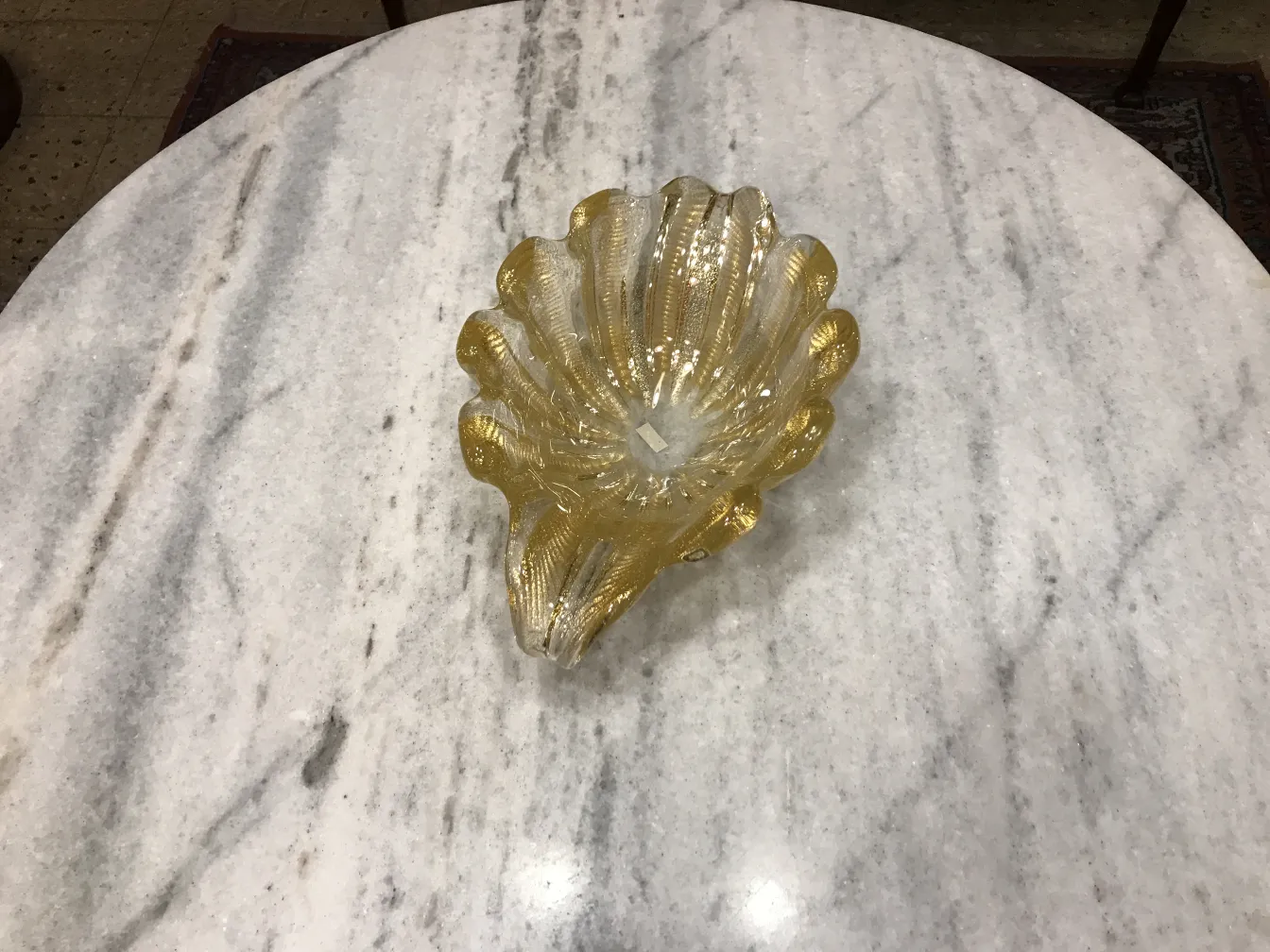 golden shell design with elegant details in glass