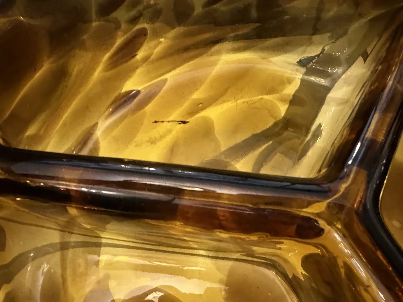 Antique Murano glass, amber color with fluid patterns