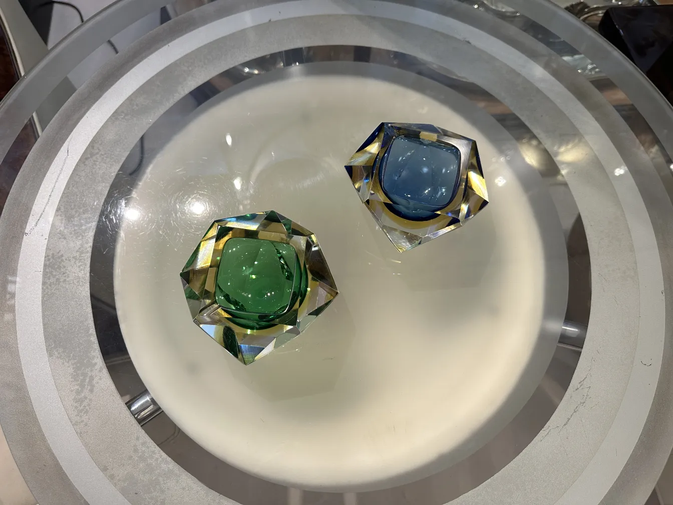 two antique murano glass pieces in green and blue on a table