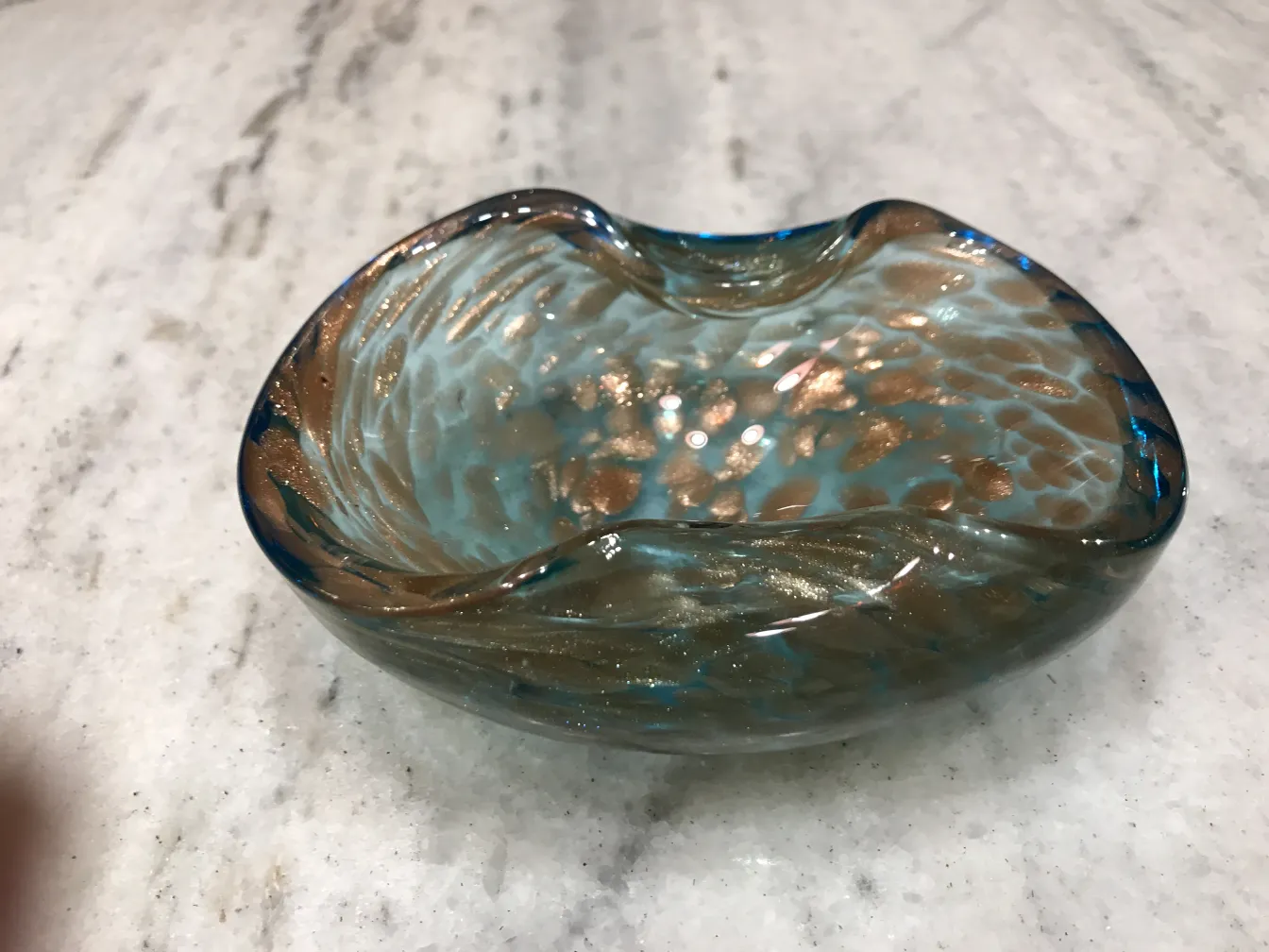 Beautiful Murano glass with curved design in blue and gold tones, perfect for decoration.