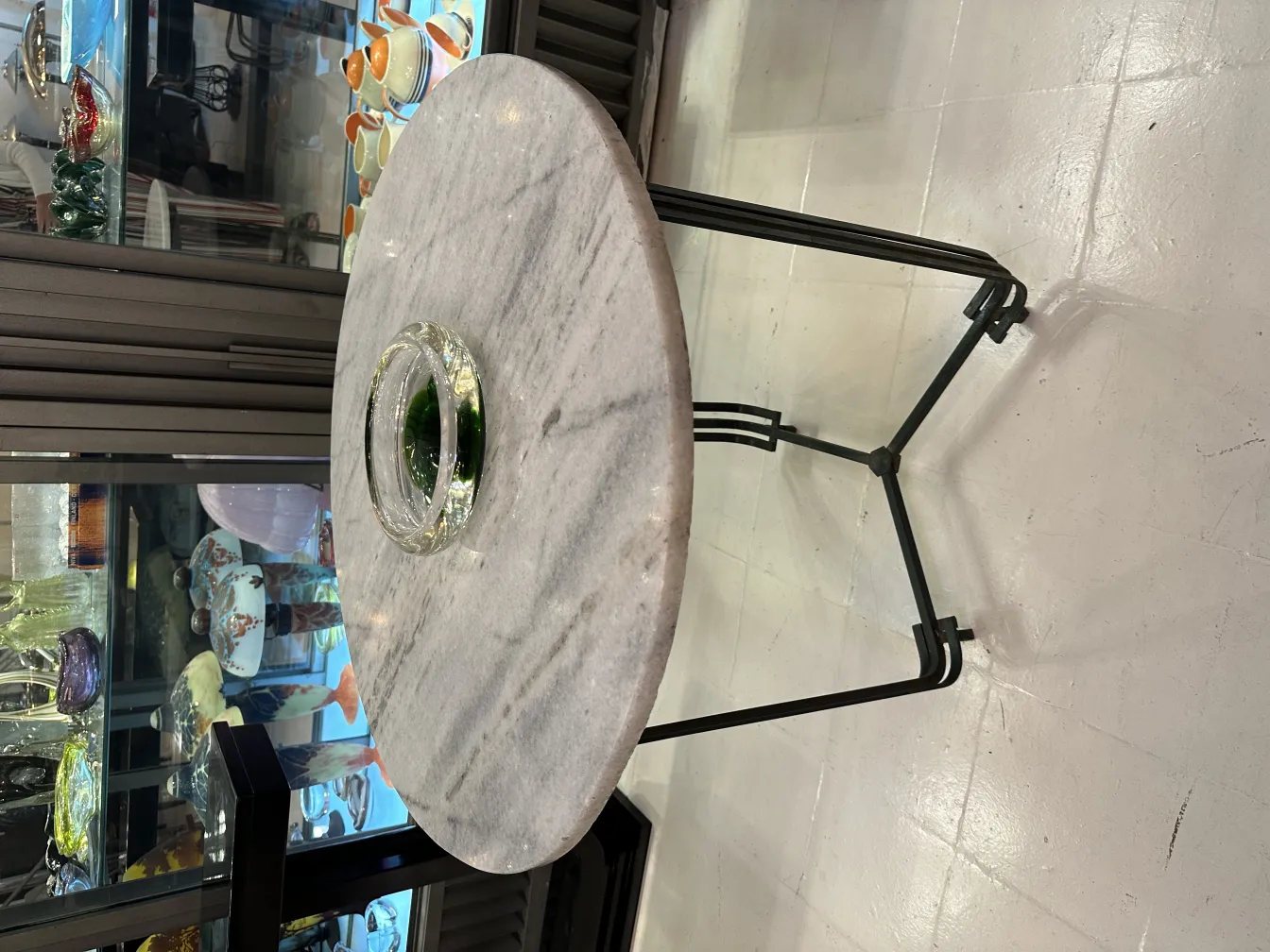 Antique Murano glass with a round shape and green base, in an elegant setting