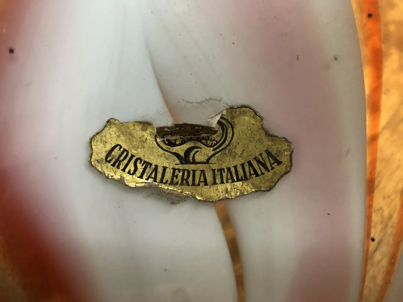 Antique Murano glass with a golden label, decorative.