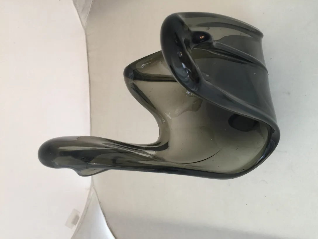 Antique Murano glass with dark hues and flowing shapes