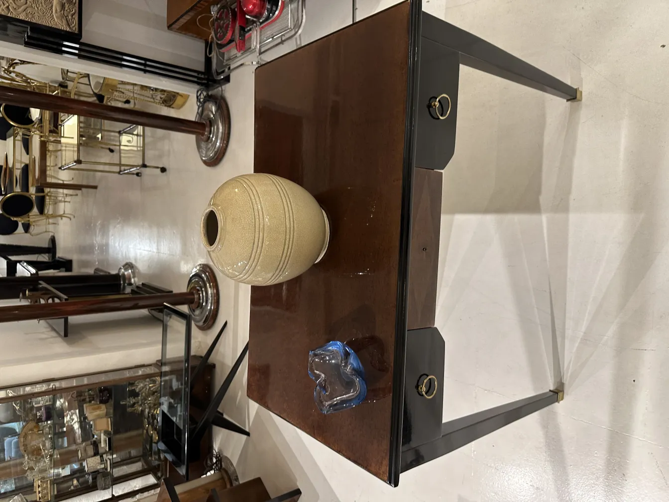 مزهرية خزفية فاتحة على الطاولة مع مرايا وزخارف عتيقة