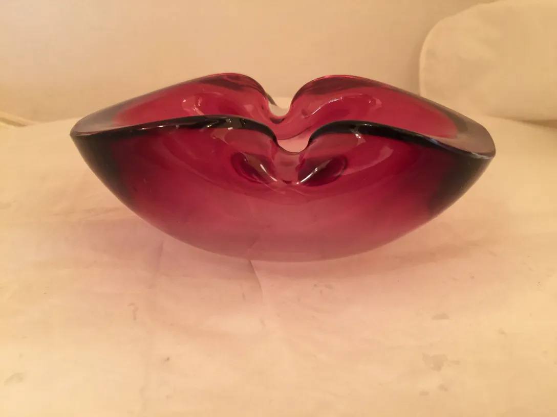 murano glass bowl with red hues and unique shape