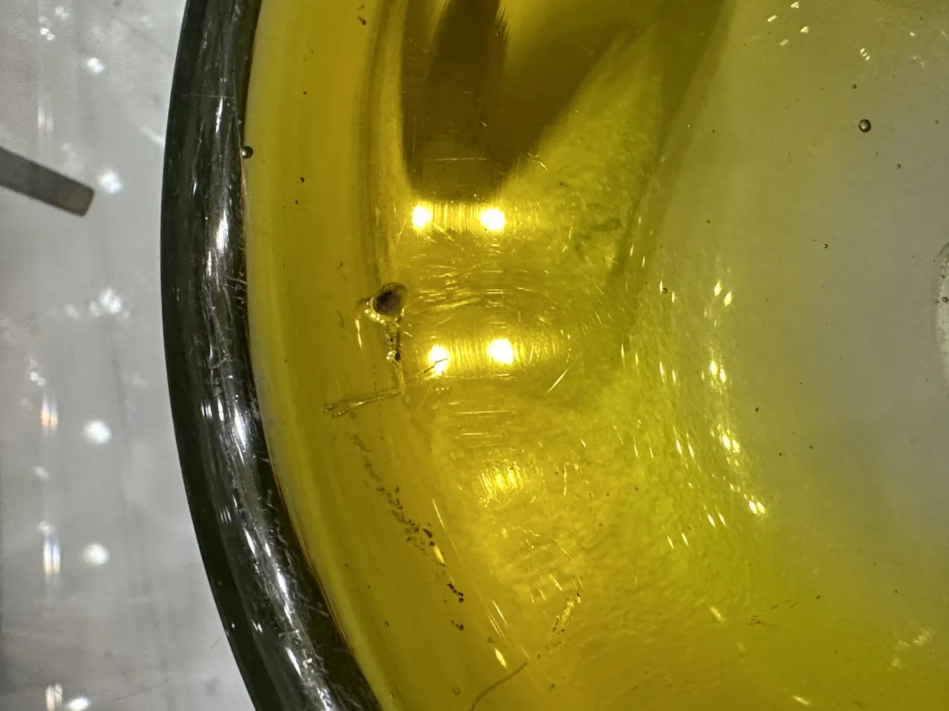 View of an antique yellow Murano glass piece, showcasing shine and varied texture