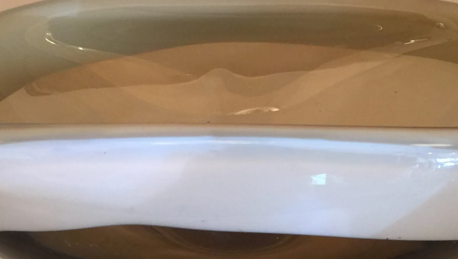 Antique Murano glass with flowing decorative details.