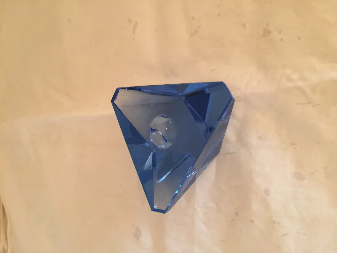 blue murano glass in geometric shape on light background