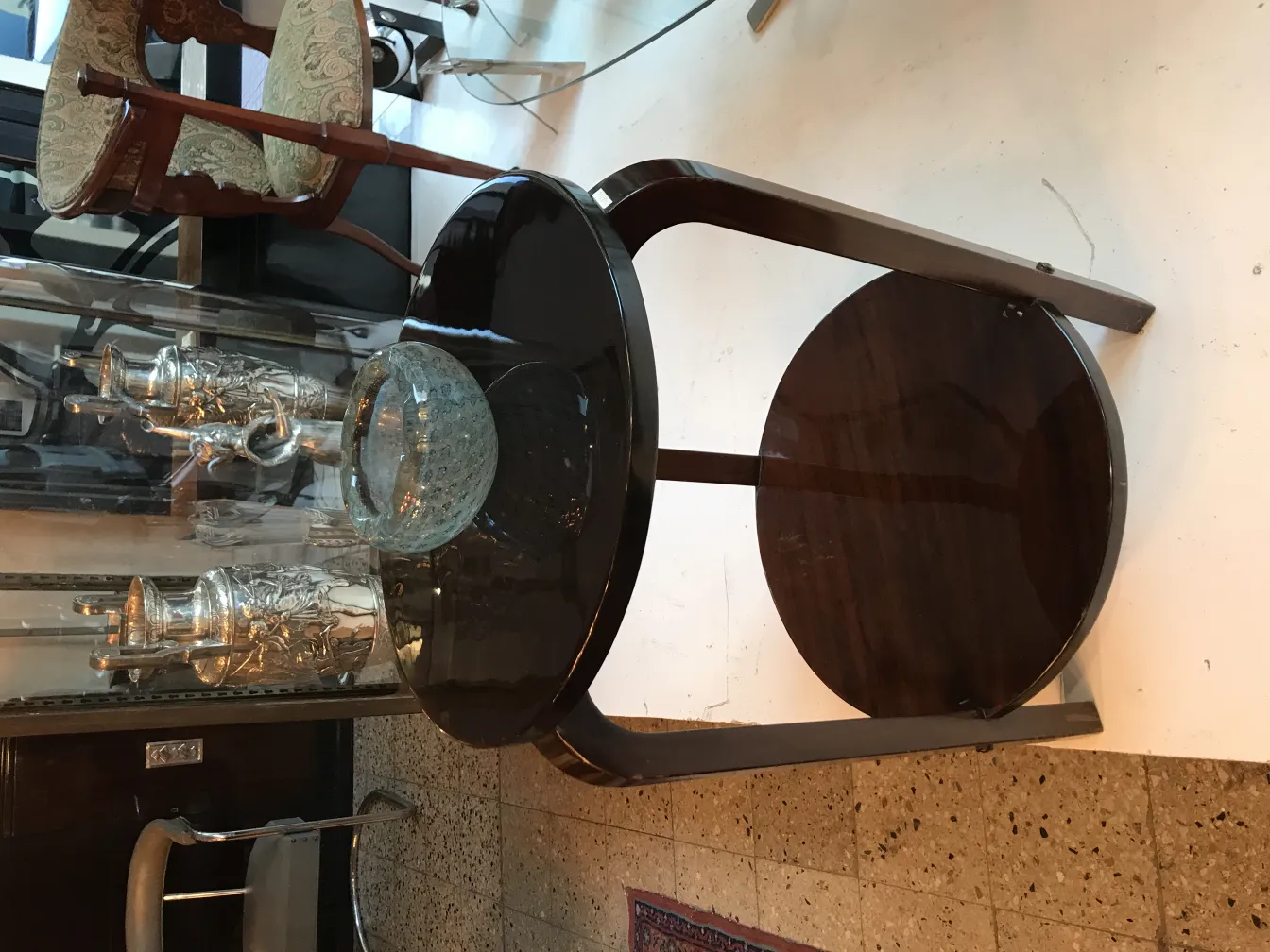 wooden antique table with decorative Murano glass and silver jugs