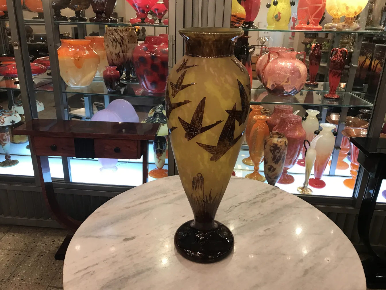 Antique glass vase signed Le Verre with bird design, yellow background.