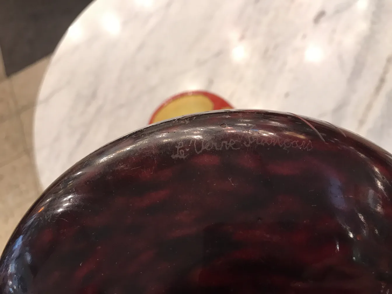 Антикварное стекло с подписью 'Le Verre', яркая обстановка.