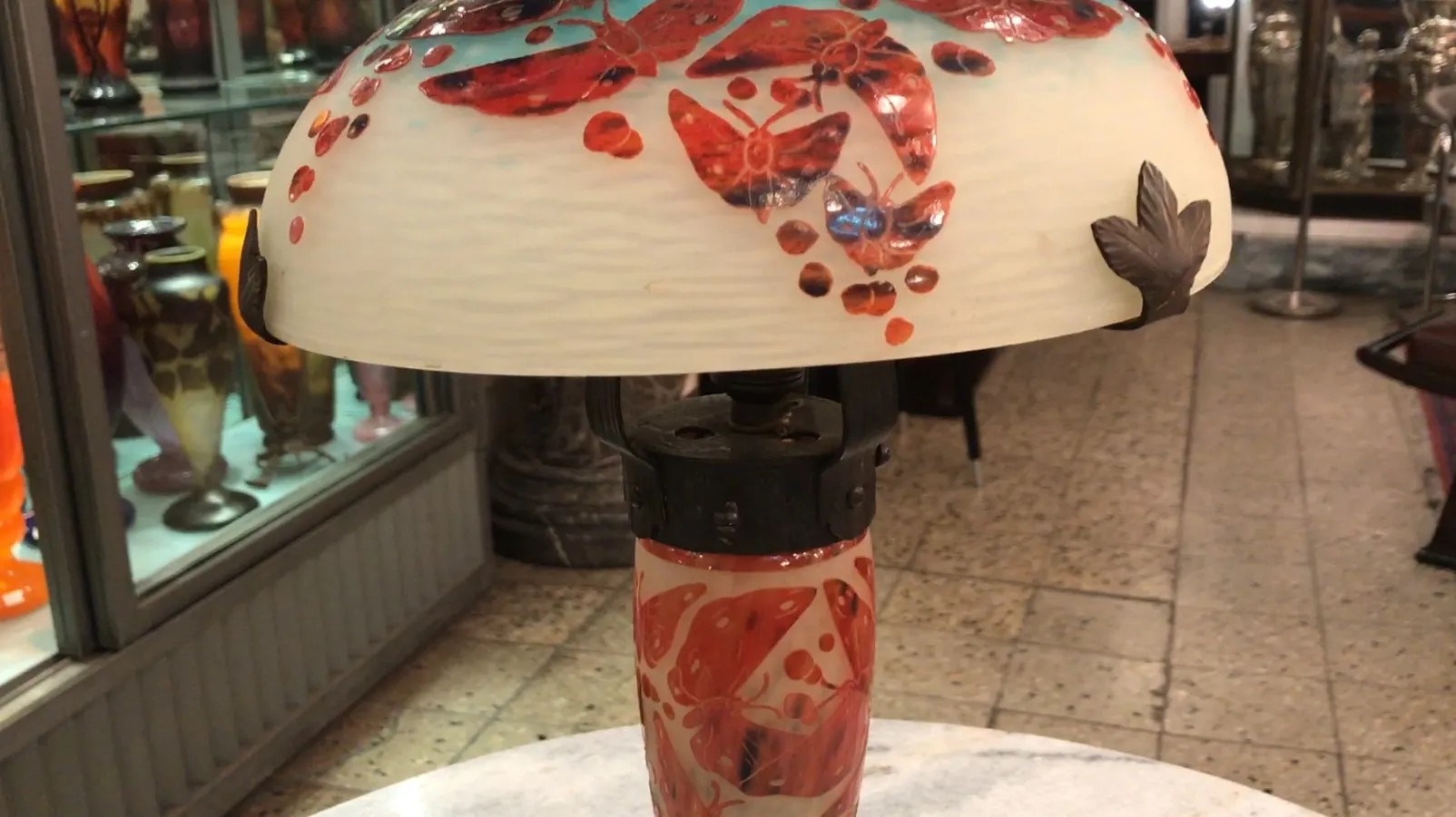 Antique lamp with decorative glass and red butterflies