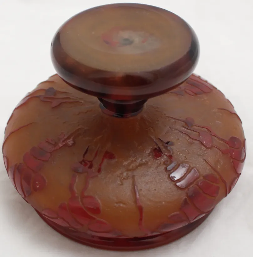 Antique glass piece with warm decorative background and top seal.