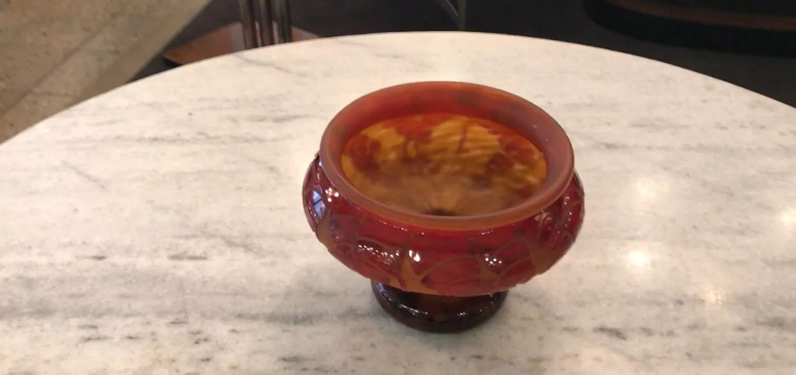 beautiful signed glass in warm tones, adorned, on table