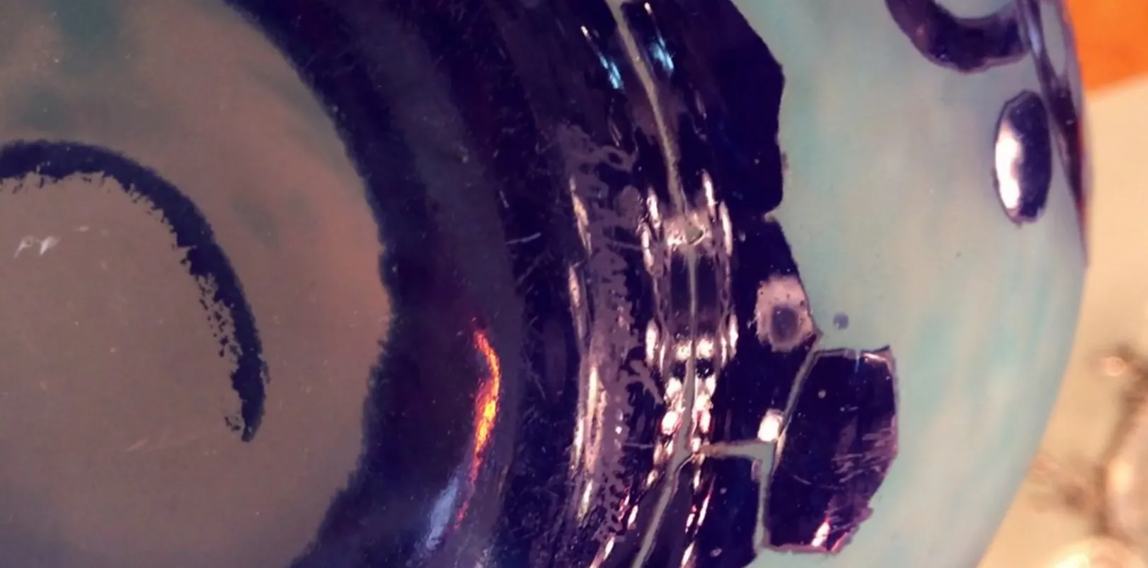 close-up of antique signed glass le verre with decorative details