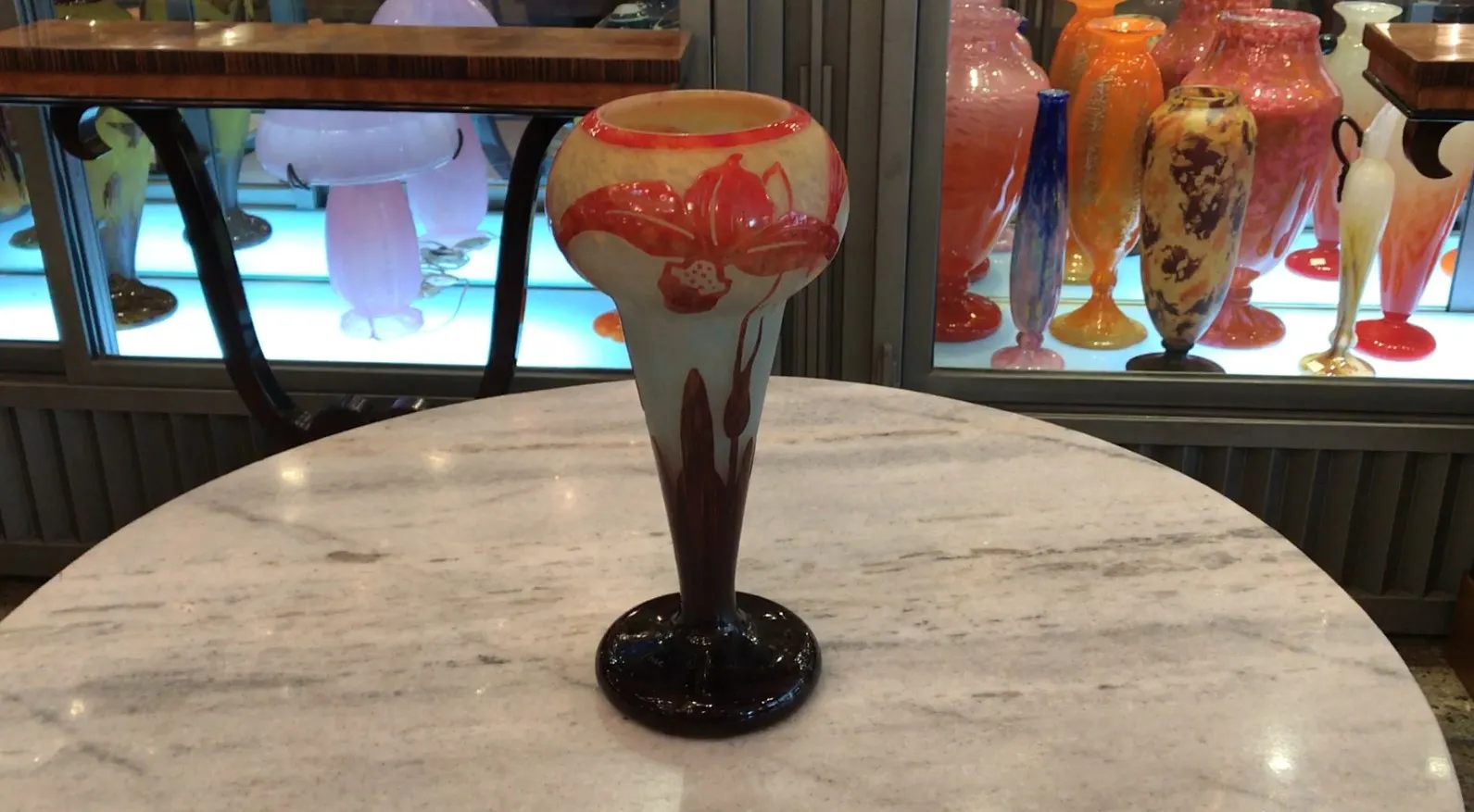 Antique vase with floral design in soft colors and dark base