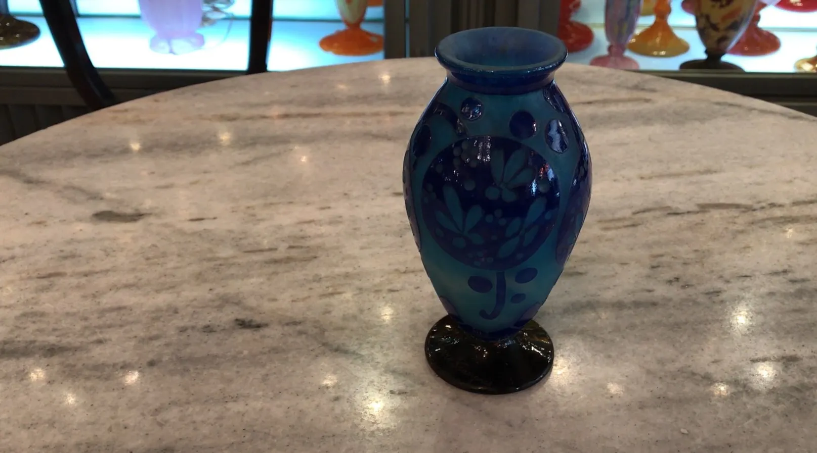 Antikes dekoratives blaues Glas mit Blumenmuster