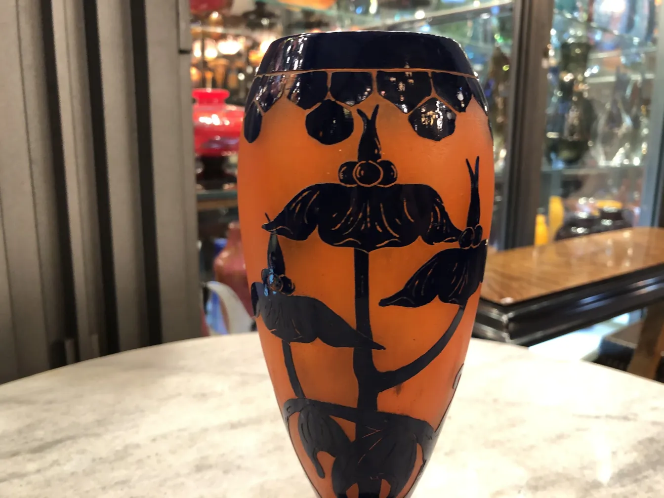 Antique vase with decorative signature and blue-orange flowers