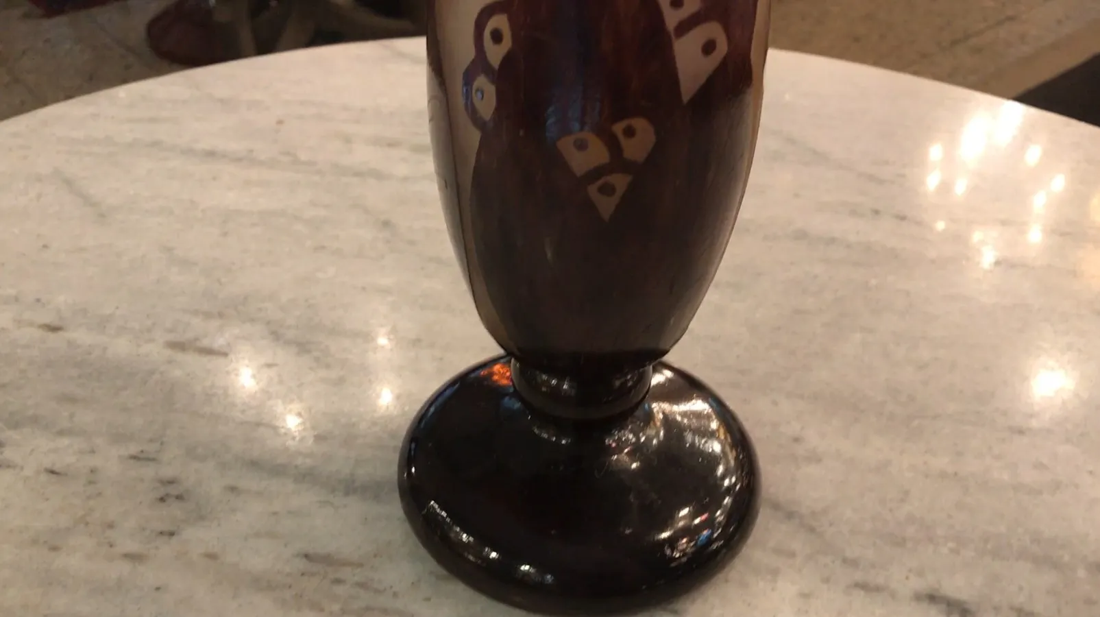 Antique signed glass with a round base and decorative details.