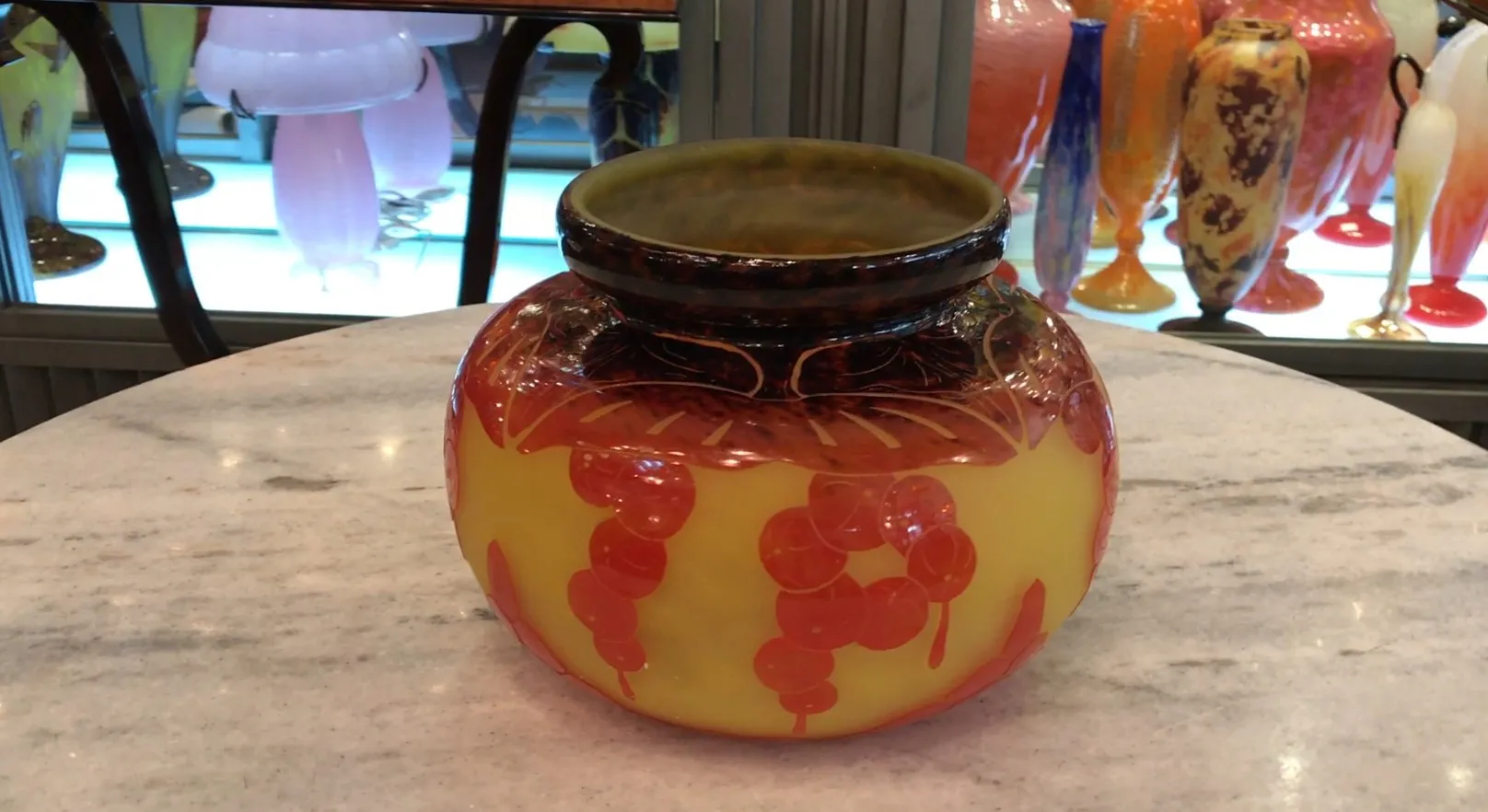 Antique glass jar with decorative details and signature.