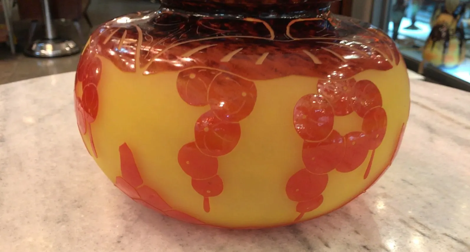 Signed glass Le Verre with yellow and orange decoration, part of an antique setting.