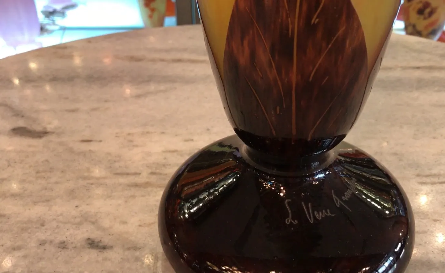 Antique signed glass with brown and light details, elegant atmosphere.