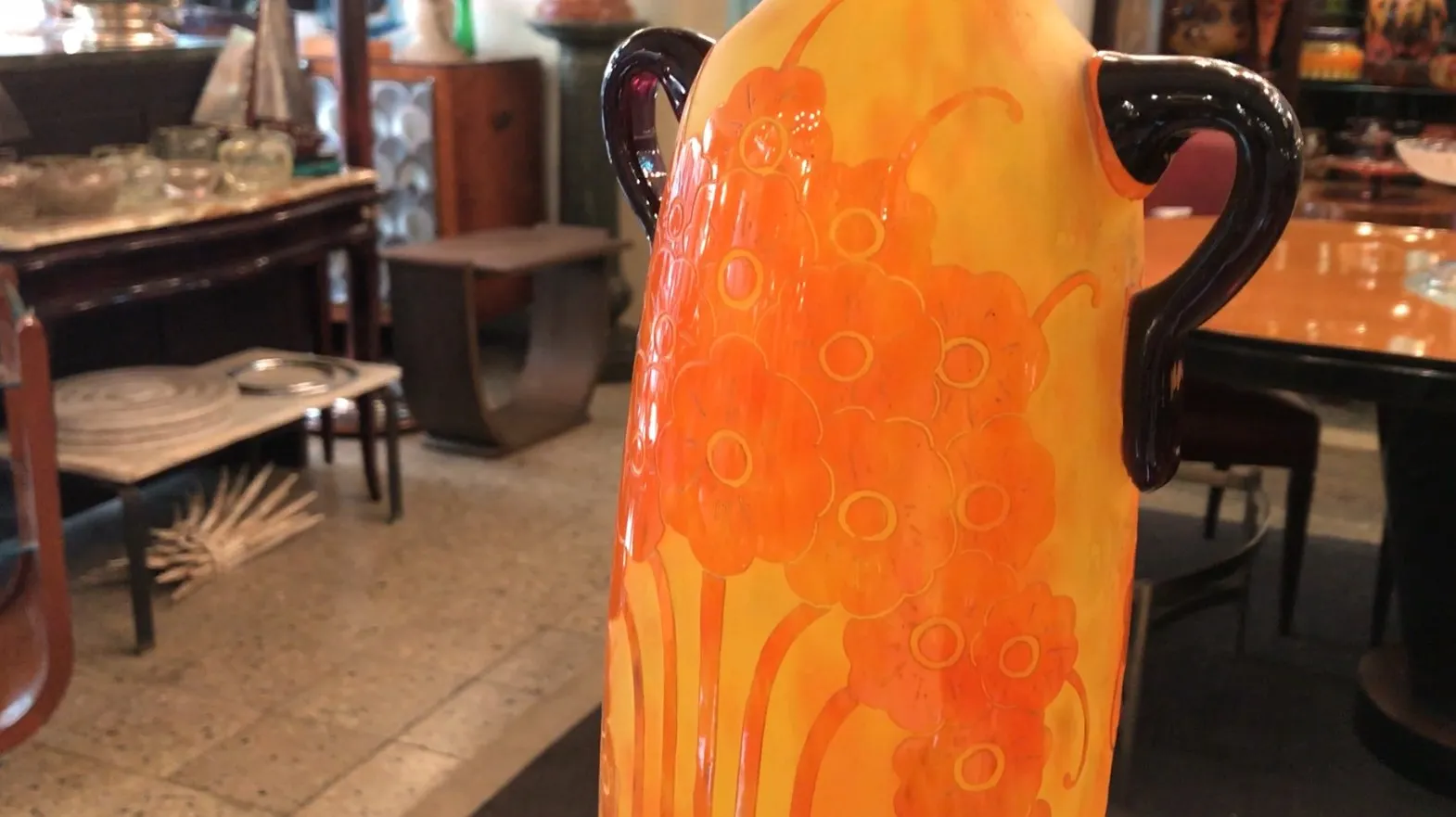 Vase ancien avec un motif floral et des couleurs vives.