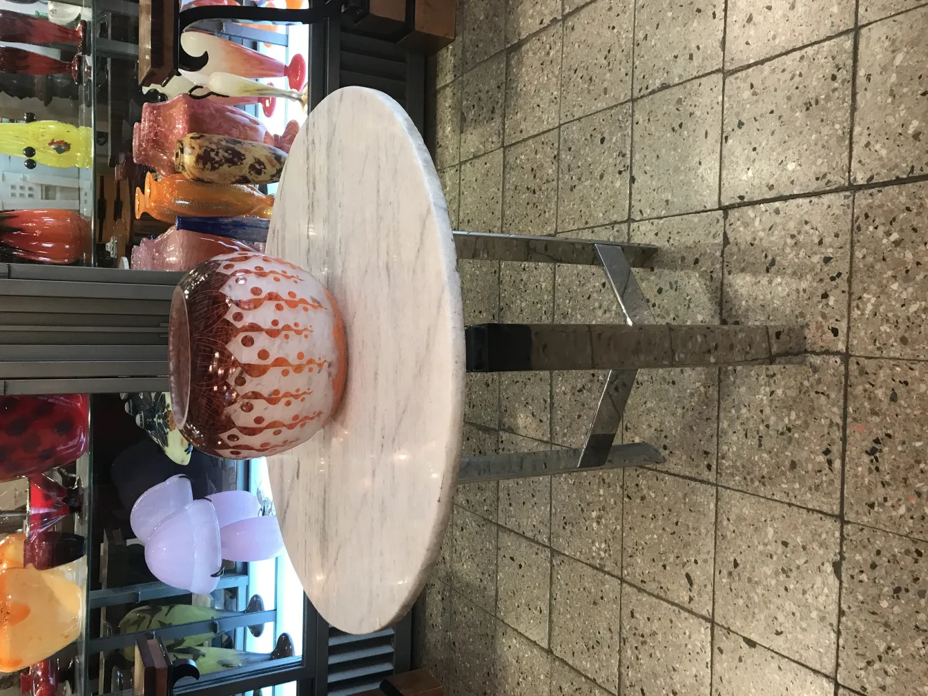 glass bowl with intricate design placed among antiques