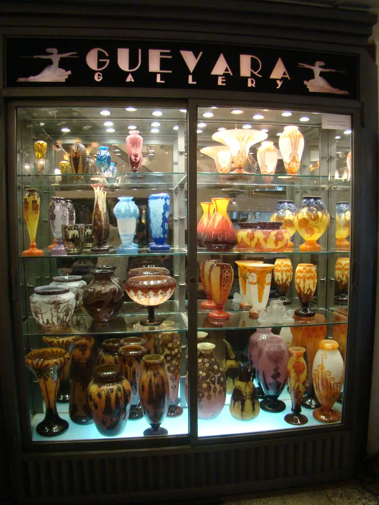 display case with various antique and colorful glass vases