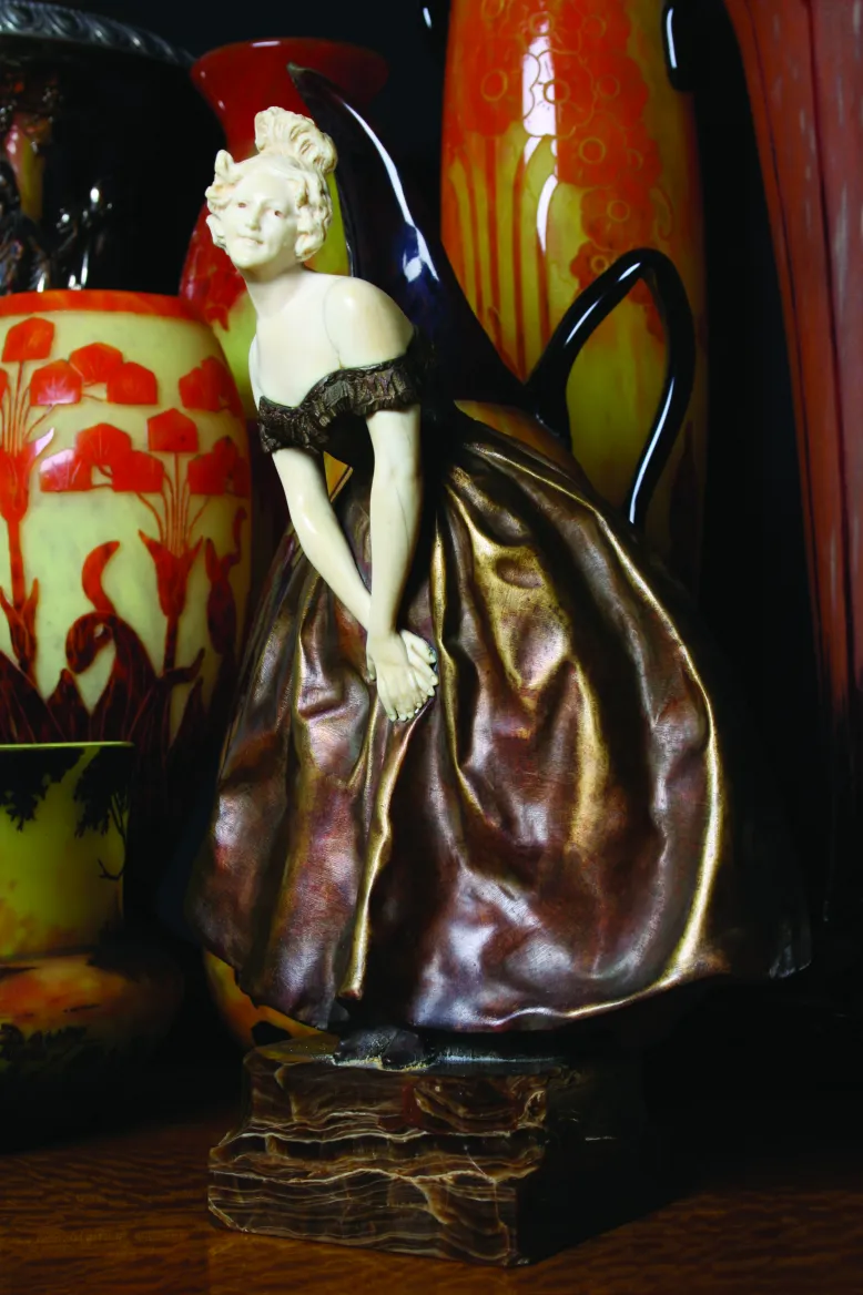 Signed glass Le Verre with a female figure and antique vases in the background.