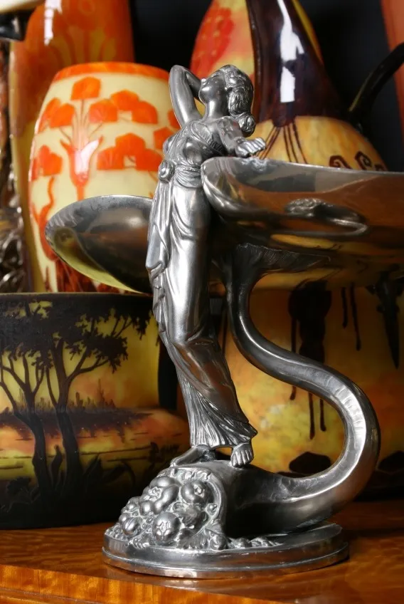 Antique figure with elegant design in signed glass, colorful background.