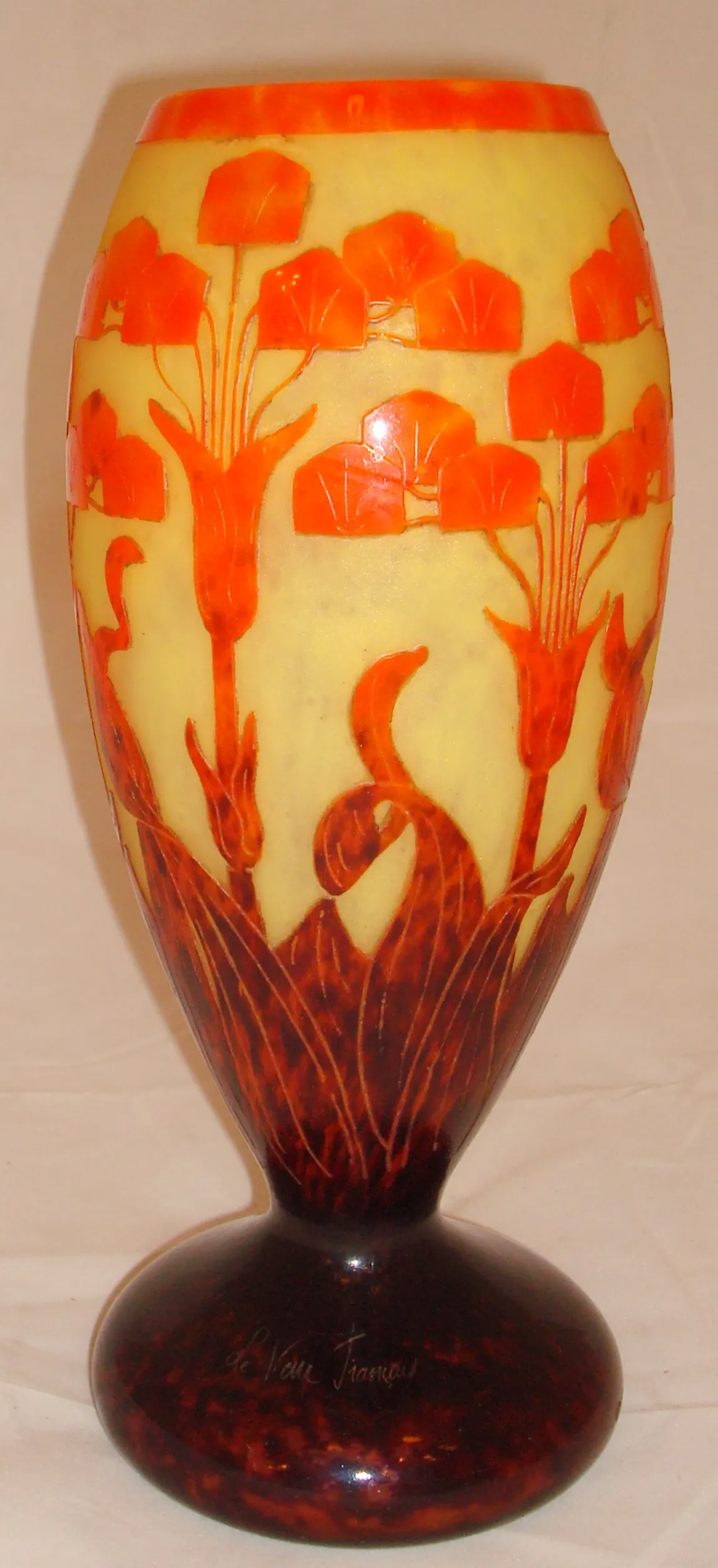 Antique glass displaying floral patterns in yellow and orange, signed Le Verre.