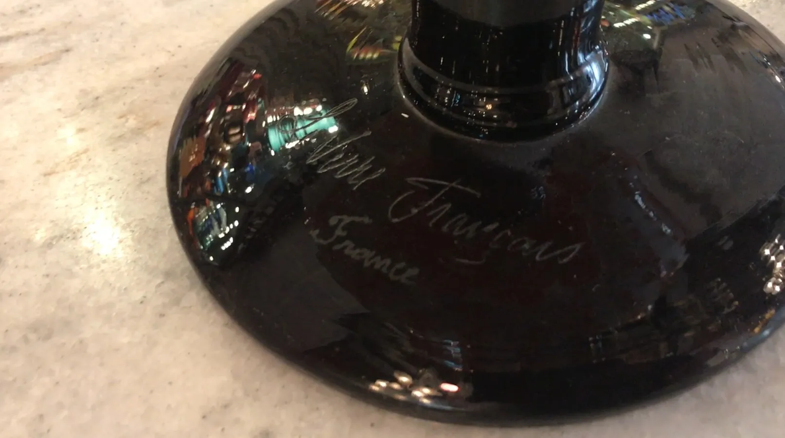 Antique signed glass Le Verre with visible signature, shiny background.