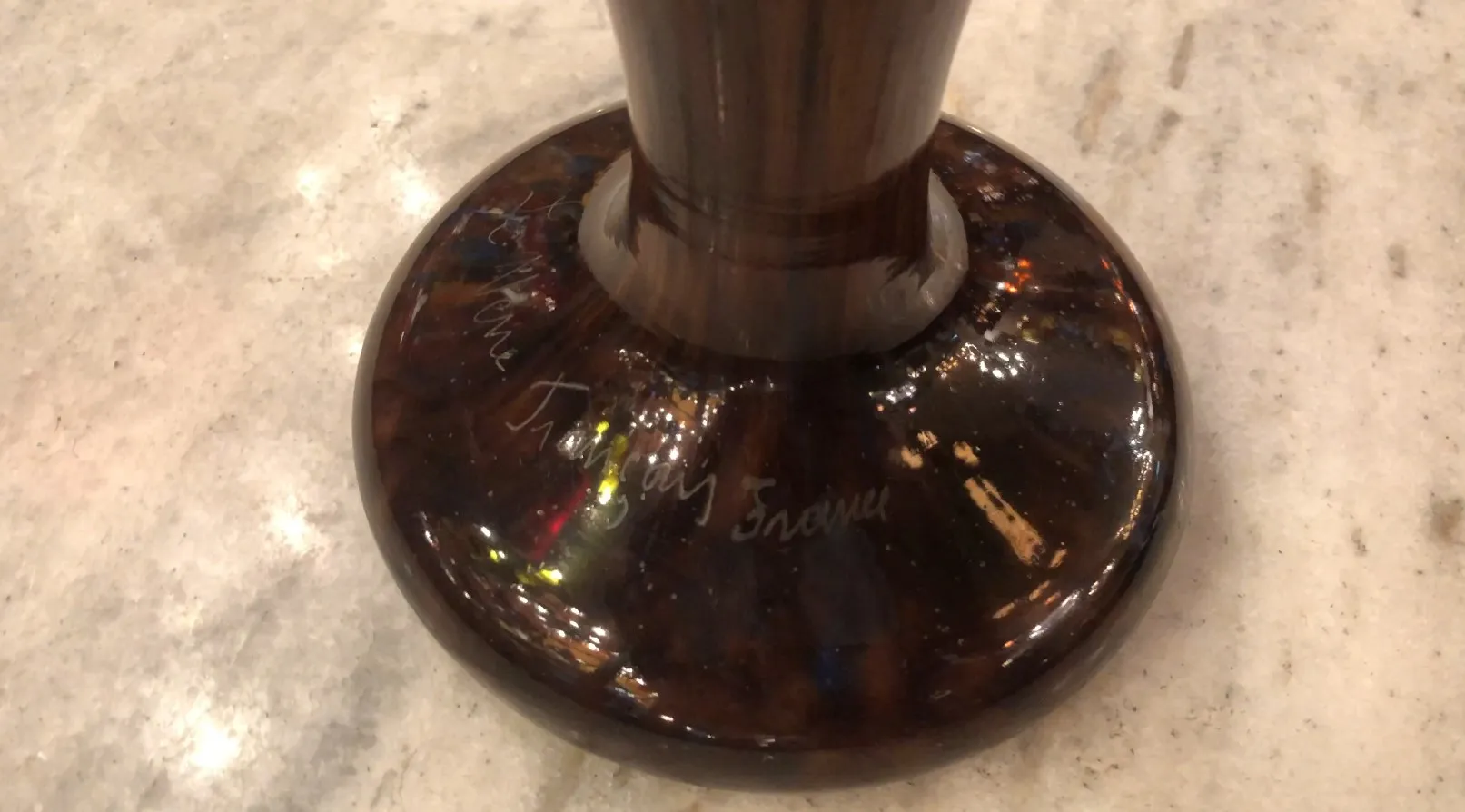 Antique signed glass showcasing vibrant decorative details.