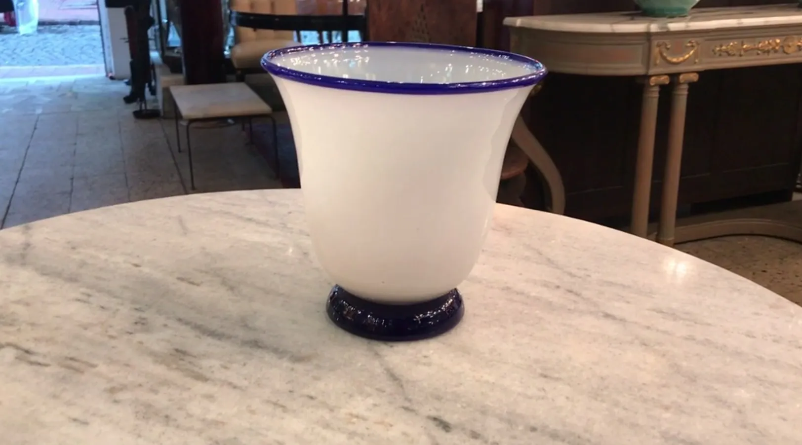 An antique glass with a blue rim, decorative in style