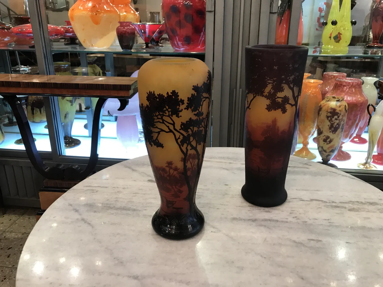 Vases of signed glass Daum Nancy on a marble table.